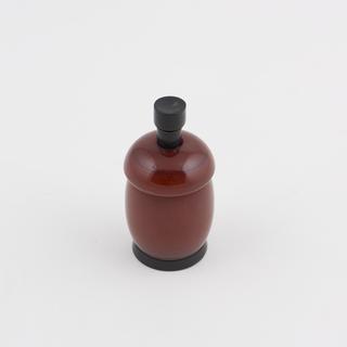 One of two spring loaded salt/pepper pots