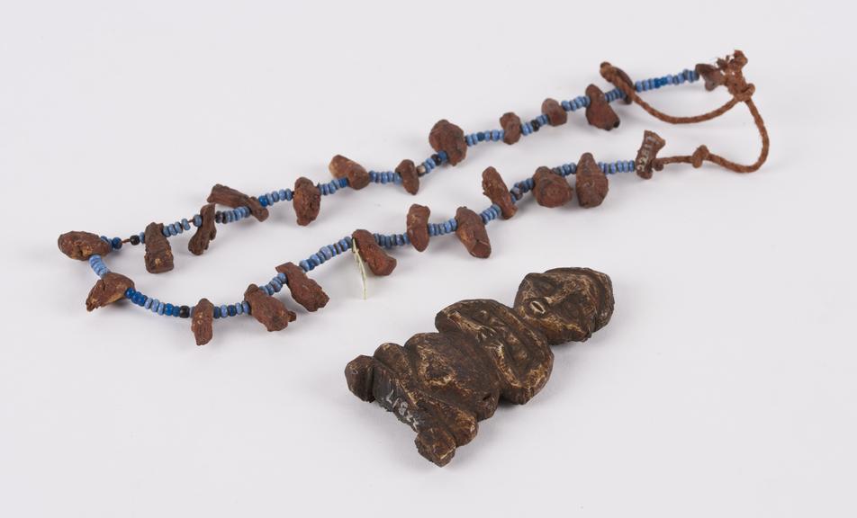 Necklace of two beads and roots with small figurine supposedly