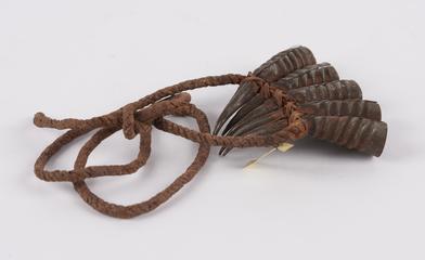 Amuletic bracelet of 5 claw-like iron horns suspended from twisted fibre string