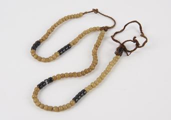 Glass bead necklace threaded on plaited fibre