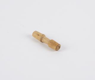 Carved wooden peg, cylindrical with waisted centre