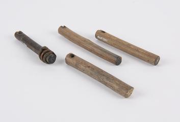 Four wooden sticks, hole near top for cord, one bound with copper coils