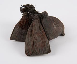 Six woven fibre bags containing straw or grasses all with cane loops