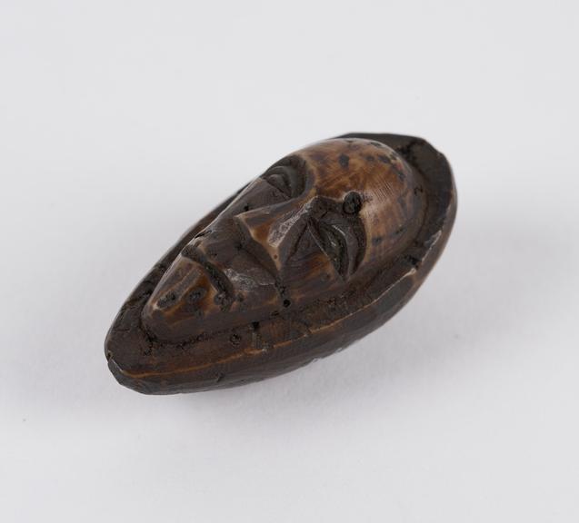 Amulet, in the form of a face, by the Bushongo tribe, Zaire