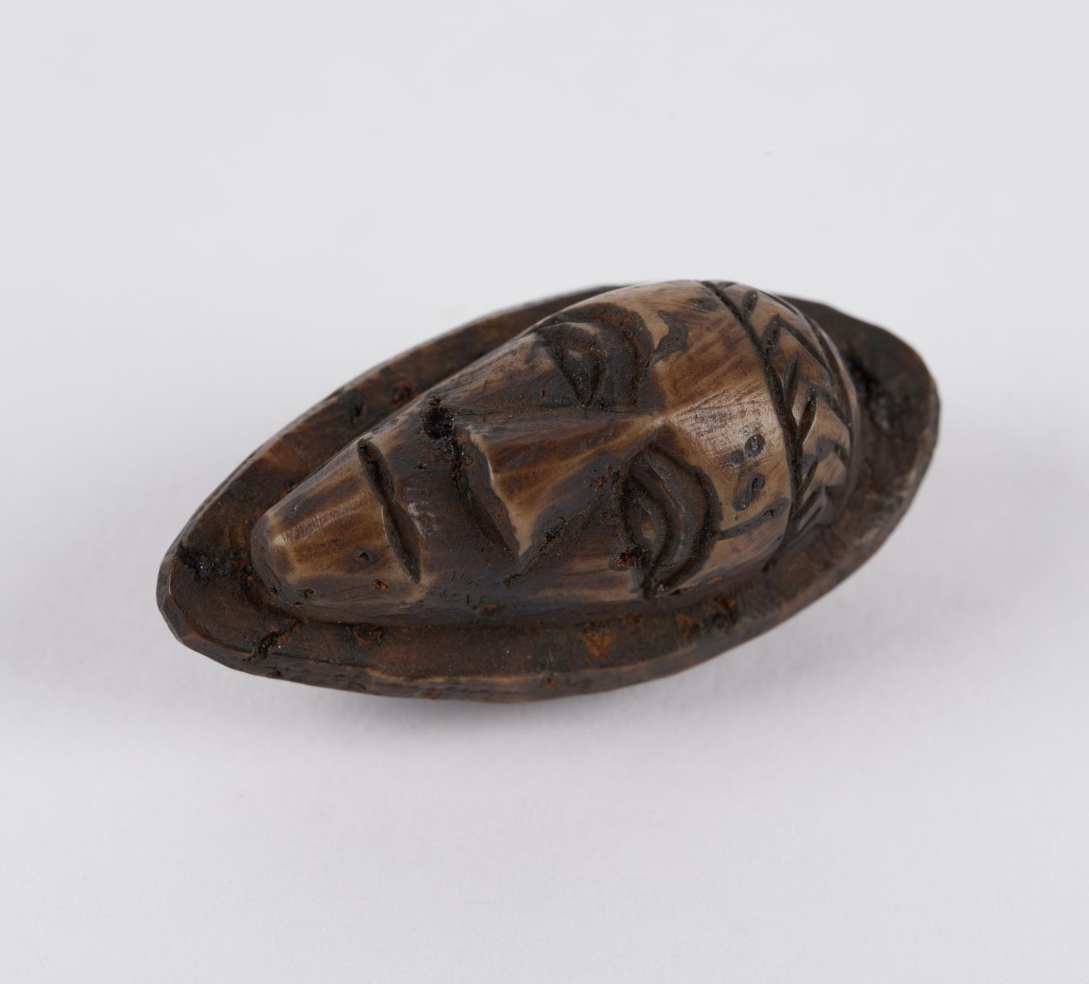 Amulet, in the form of a face | Science Museum Group Collection
