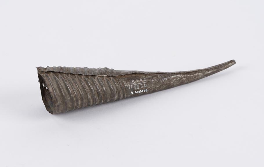 Metal protective amulet, imitating an antelope horn