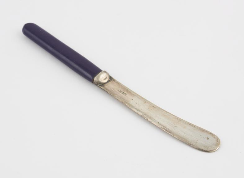 Butter knife with purple Parkesine handle; steel blades