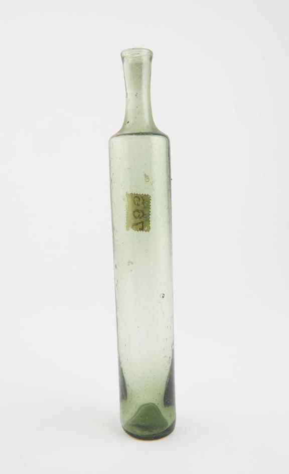 Green glass phial, in the shape of an elongated cylinder