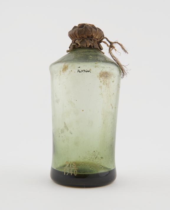 Green glass bottle for unidentified drug with small quantity of