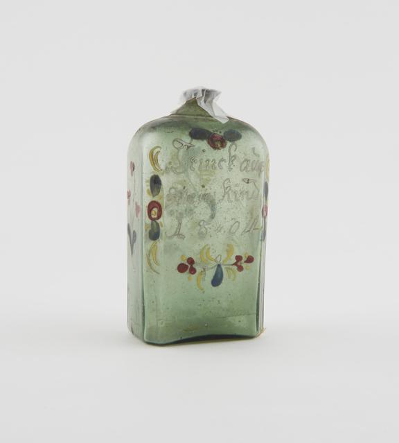 Painted green glass liquor bottle, inscribed with toast, German