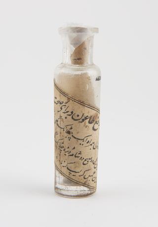 Dispensing bottle, clear glass, contains pills