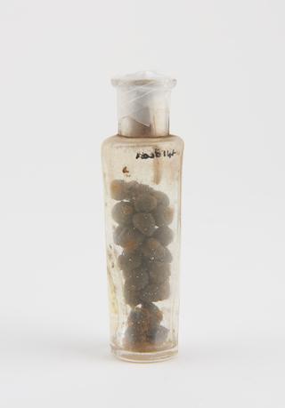 Dispensing bottle, containing brown pills