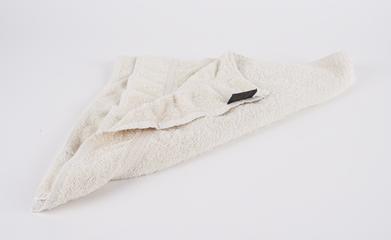 Towel. Third in a collection of four blankets and towels. Towel is cream in colour