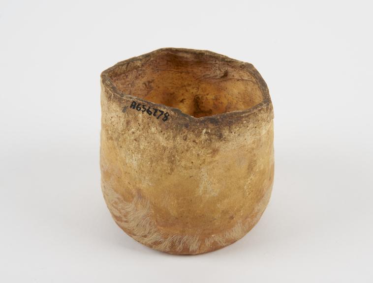 Animal hide container, shaped into a cylinder