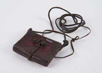 Rectangular leather amulet case containing papers