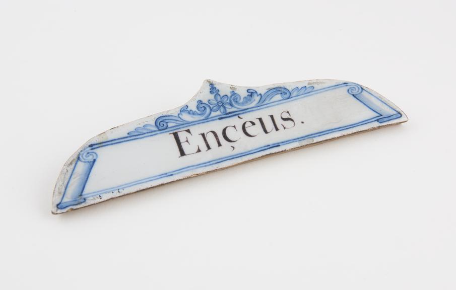 Tin-glazed earthenware drawer label, inscribed Enceus'