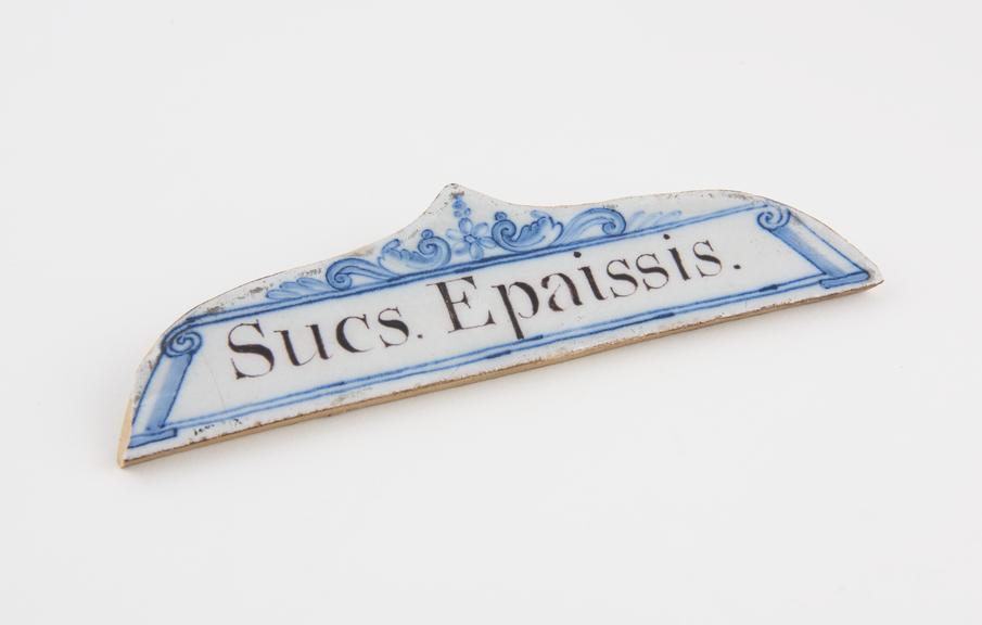 Tin-glazed earthenware drawer label, inscribed Sucs