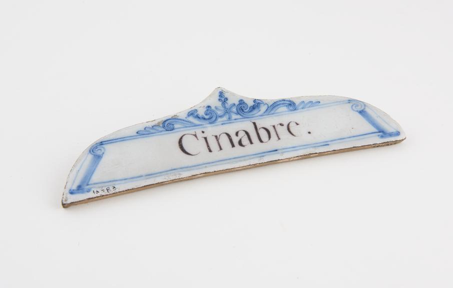 Tin-glazed earthenware drawer label, inscribed Cinabre'