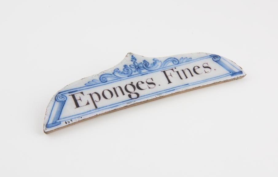 Tin-glazed earthenware drawer label, inscribed Eponges Fines'