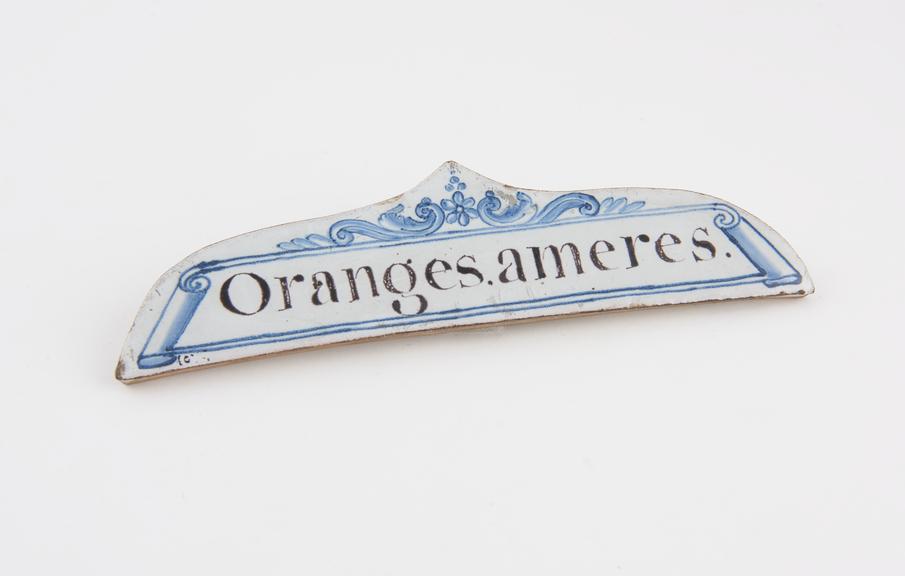 Tin-glazed earthenware drawer label, inscribed Oranges