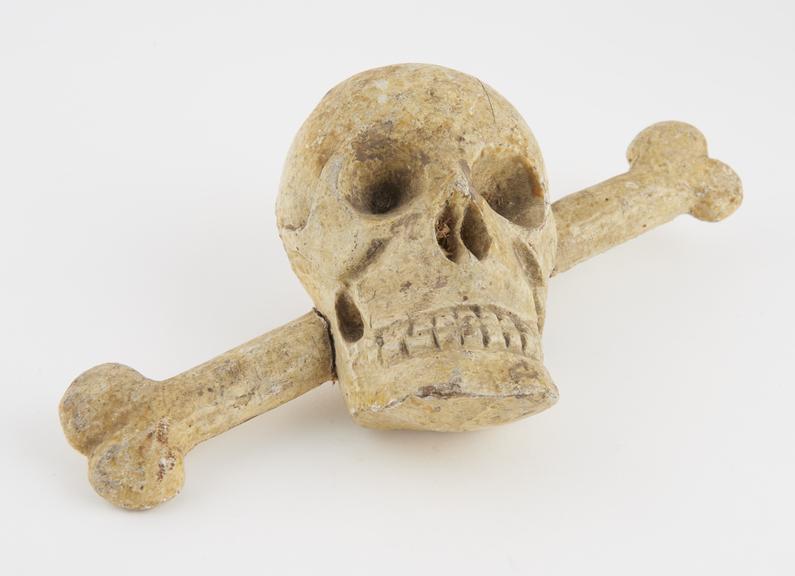 Model skull and crossbones, carved in wood