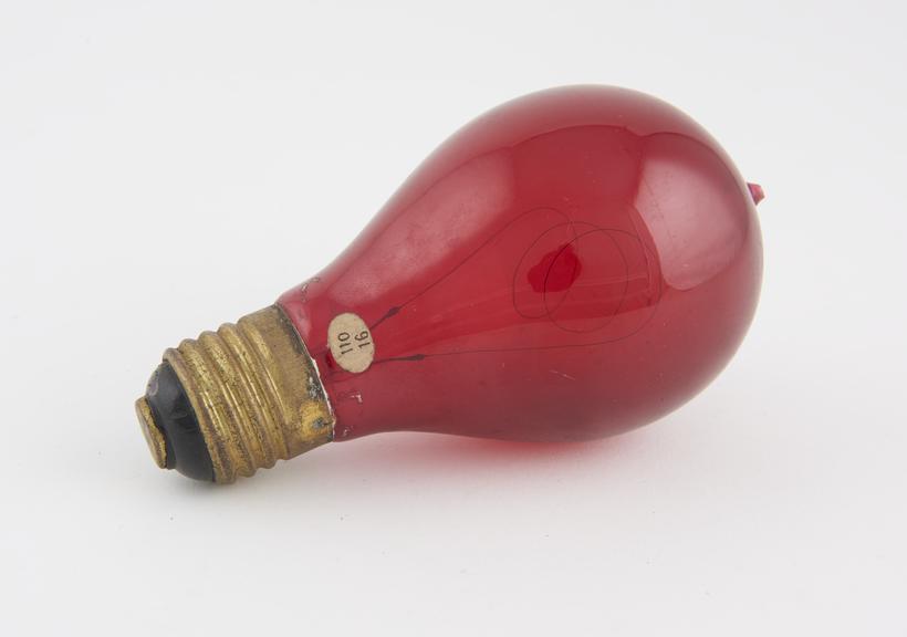 Red glass carbon filament lamp with a screw fitting by Gabriel