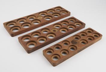 Three trays, moulds for twelve cachets