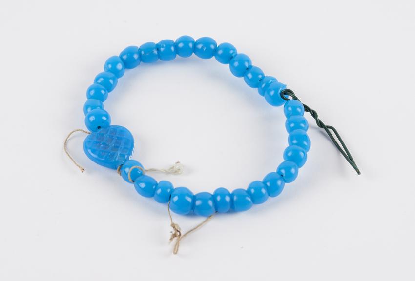 String of blue glass beads, with central heart shaped bead