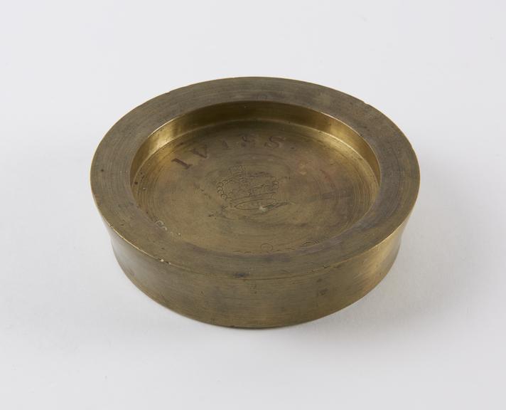 One of three Indian circular saucer shape weights  from a set