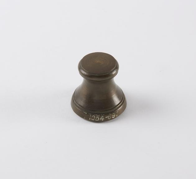 One of eight Indian brass weights, stool shaped