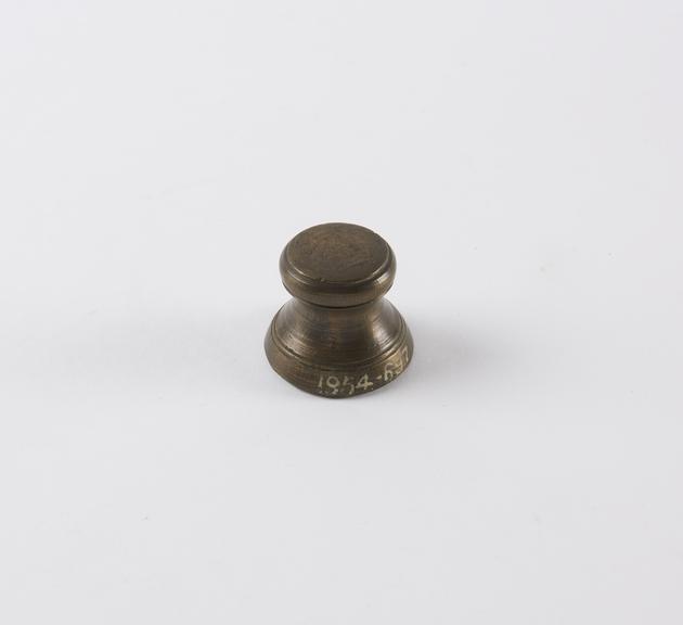 One of eight Indian brass weights, stool shaped