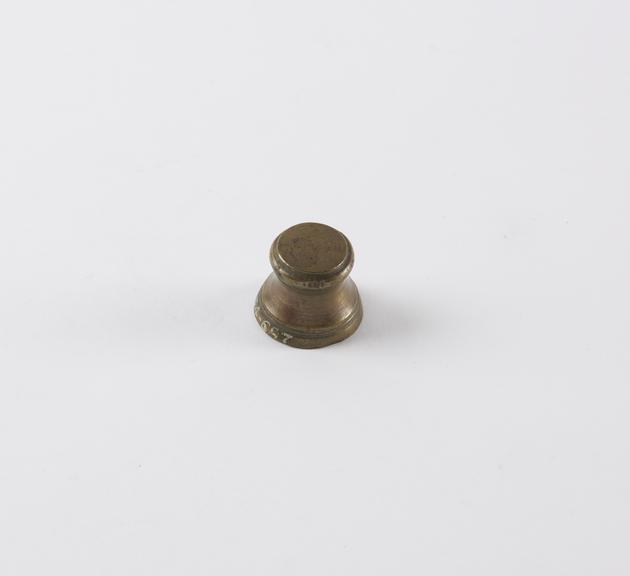 One of eight Indian brass weights, stool shaped