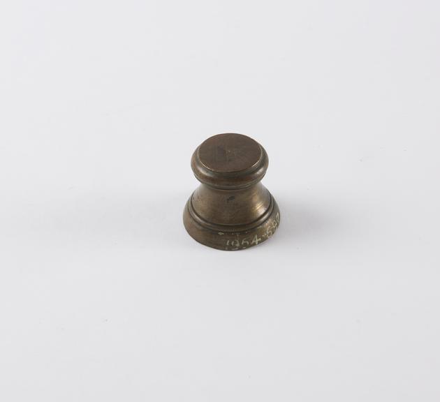 One of eight Indian brass weights, stool shaped