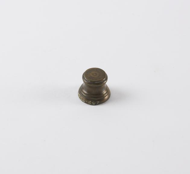 One of eight Indian brass weights, stool shaped