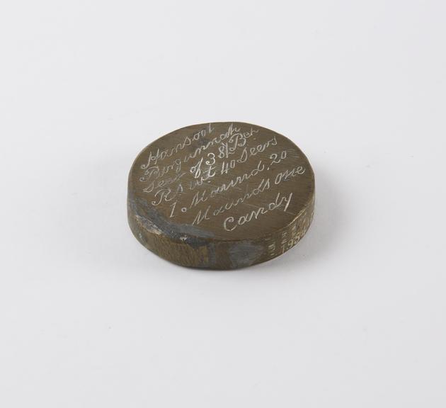 One of eleven Indian weights, all brass flat circular