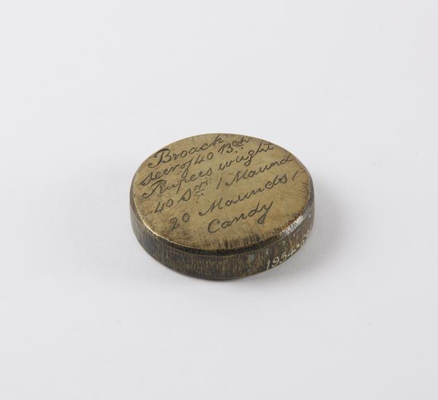 One of eleven Indian weights, all brass flat circular