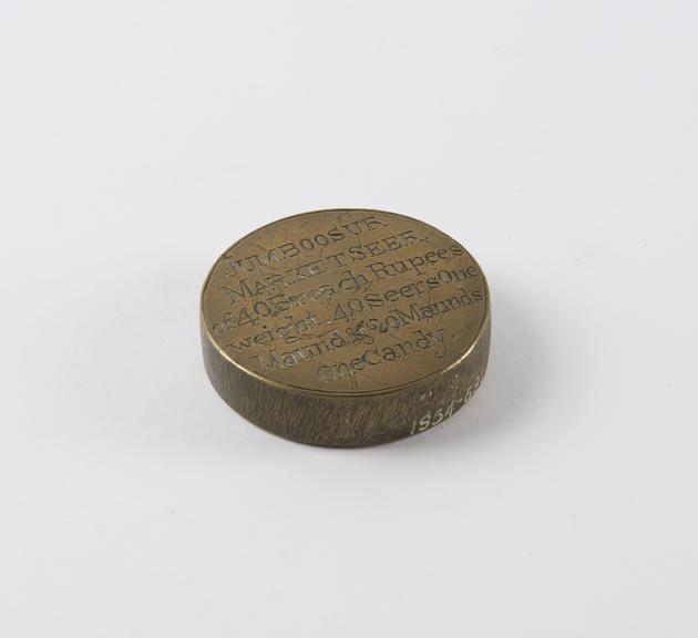 One of eleven Indian weights, all brass flat circular