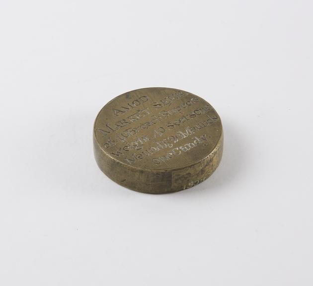 One of eleven Indian weights, all brass flat circular