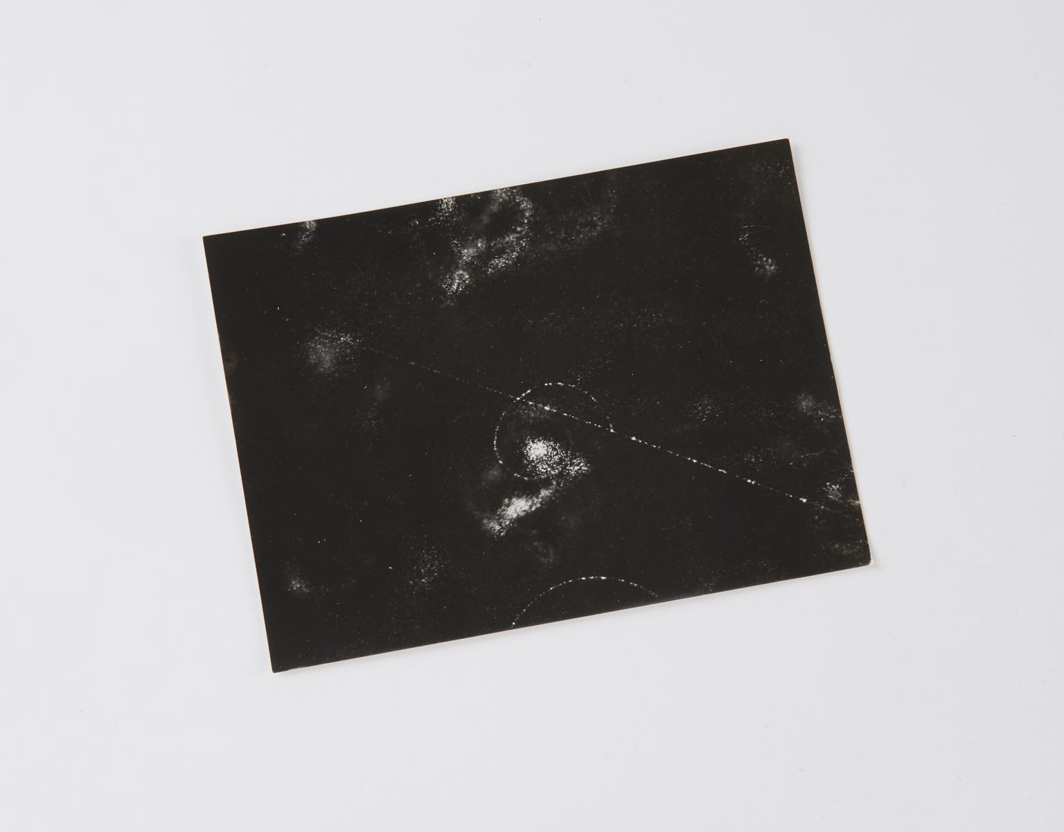 Black and white photographic print, taken with a deep expansion chamber, showing cosmic-ray tracks in oxygen