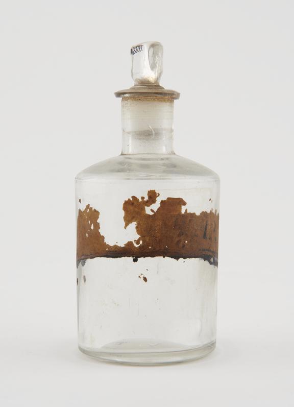 Bottle, clear glass, empty, label illegible, English