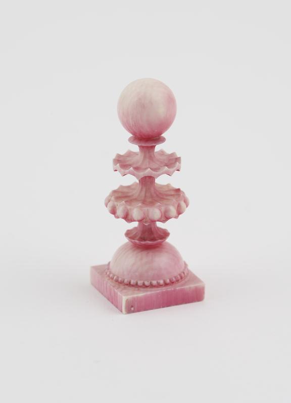 A Pawn, one of sixteen ivory chessmen, covered with a pink wash