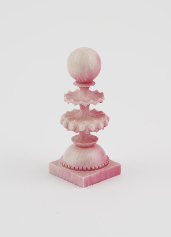 A Pawn, one of sixteen ivory chessmen, covered with a pink wash