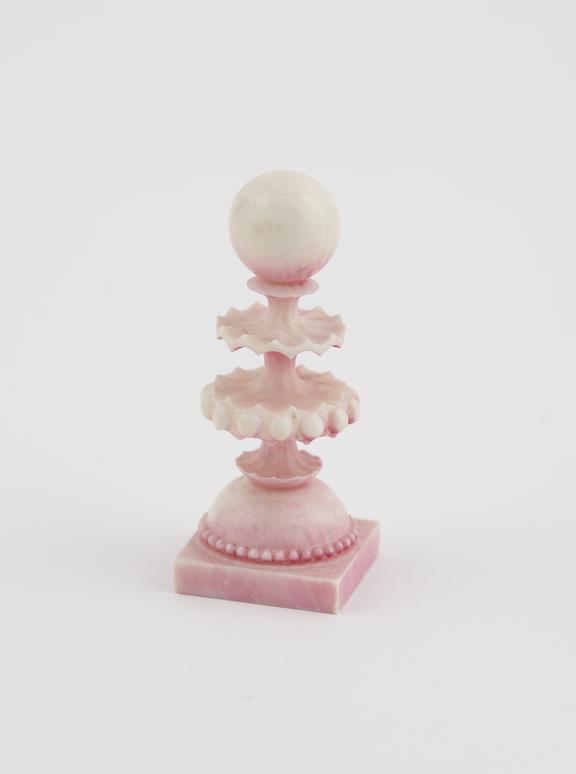 A Pawn, one of sixteen ivory chessmen, covered with a pink wash