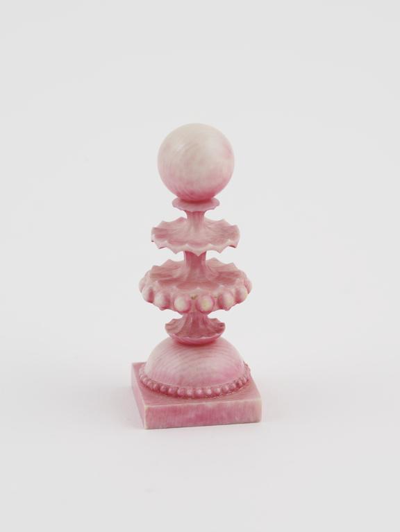 A Pawn, one of sixteen ivory chessmen, covered with a pink wash