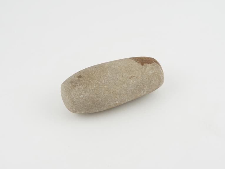 Ovoid creamy brown stone with flattened ends, used as pounder