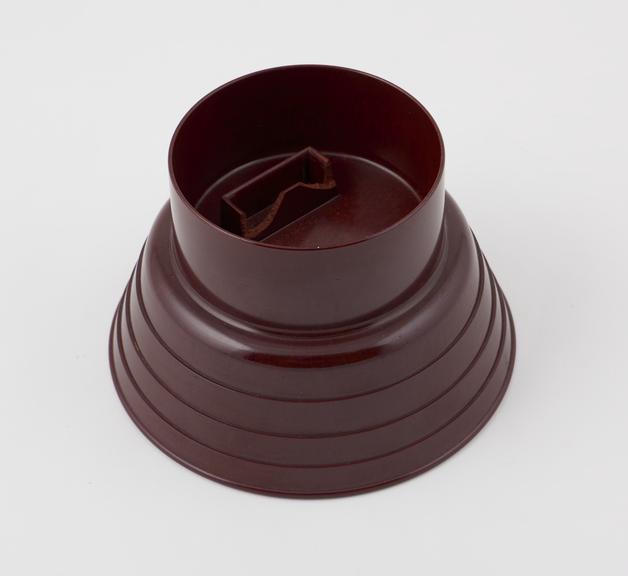 Reddish, circular bowl with fluted sides