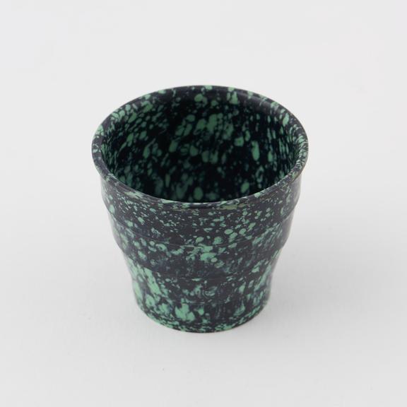 Egg cup made of mottled green/black urea formaldehyde