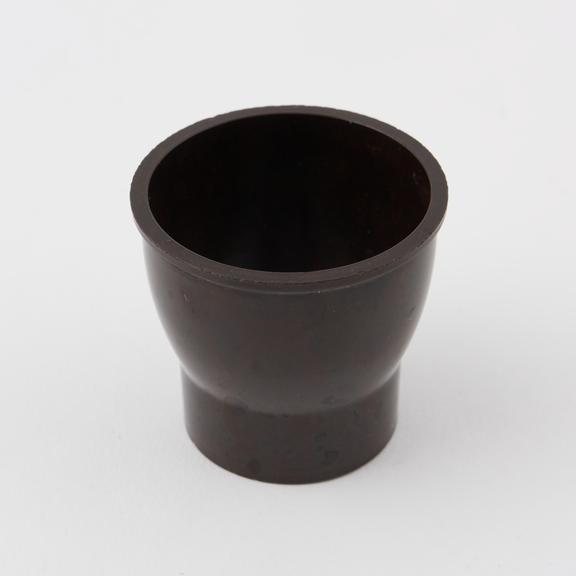 Egg cup made of mottled dark brown/brown phenolic