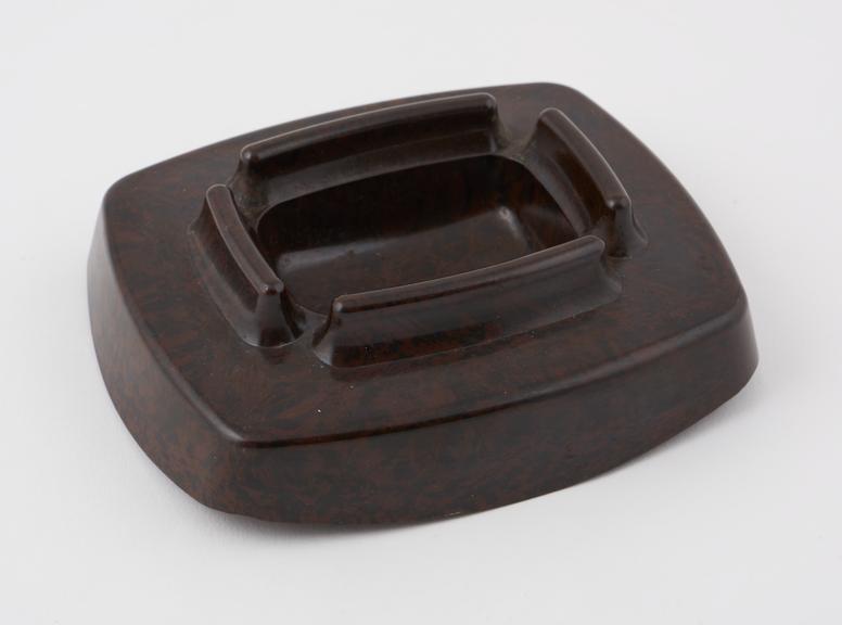 Ashtray made of mottled dark brown/brown phenolic