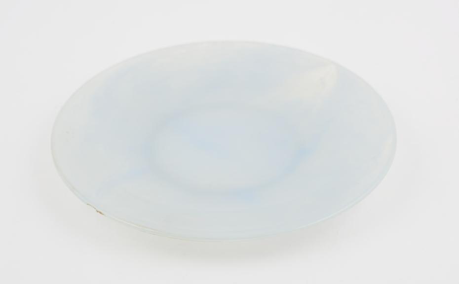 Circular plate of pale blue and clear marbled polystyrene